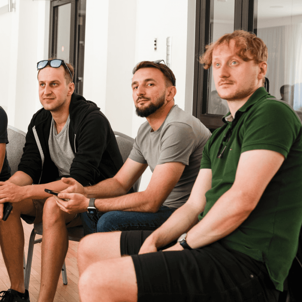 Mens sitting in a conference room, engaged in a discussion