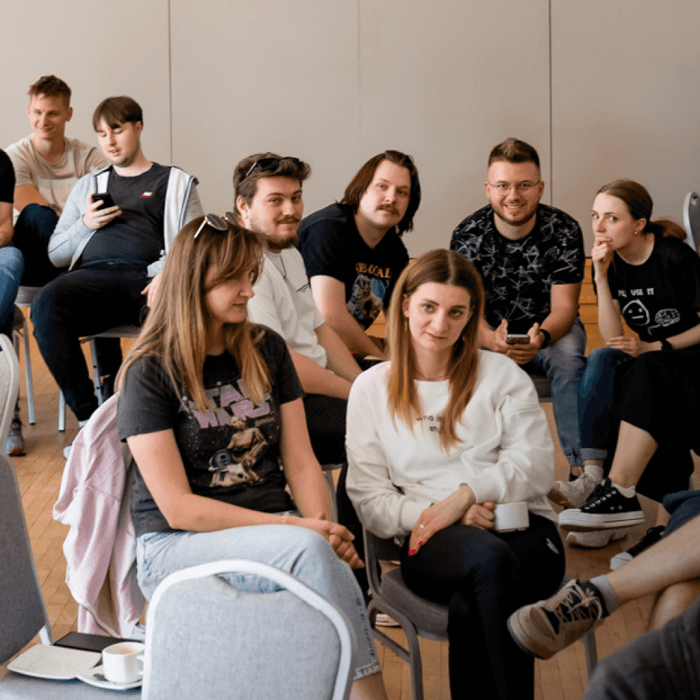 Group of people sitting and chatting in a conference room